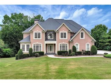 Two-story house with a large front yard and a three-car garage at 1426 Greenridge Trl, Lithonia, GA 30058