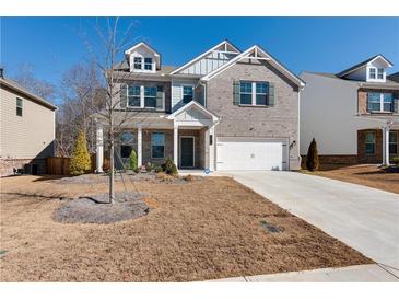 Two-story brick home with a large front yard and attached garage at 1076 Allspice Way, Lawrenceville, GA 30045