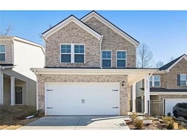 Charming two-story brick home with a two-car garage and well-maintained landscaping at 4722 Blake Loop, Atlanta, GA 30349