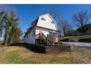 Inviting two-story home featuring a charming entryway, updated landscape, and unique architectural details at 109 Shirley Se Ln, Acworth, GA 30101