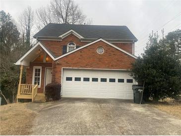 Brick two-story house with attached garage and landscaping at 1759 Bertram Sw Ln, Marietta, GA 30008