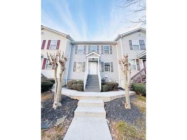 Two-story townhome with gray siding, gray stairs, and landscaping at 420 Old Holcomb Bridge Rd, Roswell, GA 30076