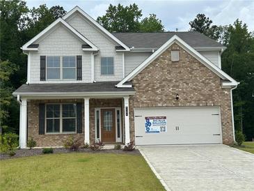 Charming brick and gray two-story home with covered front porch at 2180 Highridge Point Dr, Lithia Springs, GA 30122