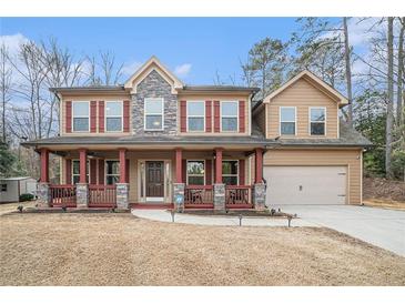 Two-story house with stone accents, red shutters, and a porch at 1005 Greenridge Trail, Loganville, GA 30052