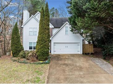 Two-story white house with driveway, landscaping, and double garage at 2958 Arden Ridge Ter, Suwanee, GA 30024
