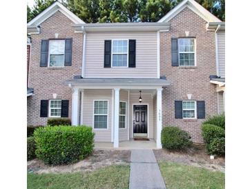 Two-story brick home with a covered porch and landscaping at 2555 Flat Shoals Rd # 3005, South Fulton, GA 30349