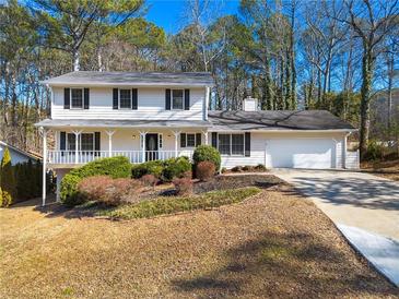 Two-story house with white siding, black shutters, and a landscaped yard at 4642 Mahonia Nw Way, Acworth, GA 30102