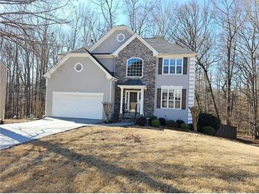 Two-story house with stone accents and a large front yard at 355 Holland Springs Way, Powder Springs, GA 30127