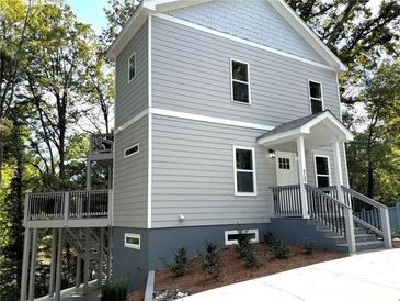 Two-story gray house with deck and landscaping at 2125 Clay Rd, Austell, GA 30106