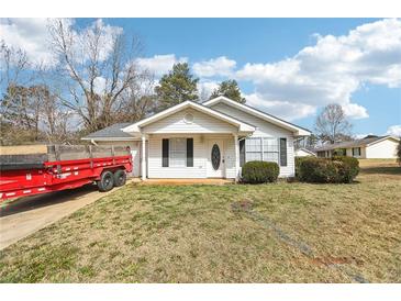 Charming single-story home with manicured shrubs in the front yard, offering great curb appeal at 50 Silver Tip Ct, Mcdonough, GA 30253