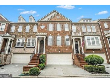 Brick front of charming townhome with attached two-car garage at 5104 Leeshire Se Trl # 64, Atlanta, GA 30339