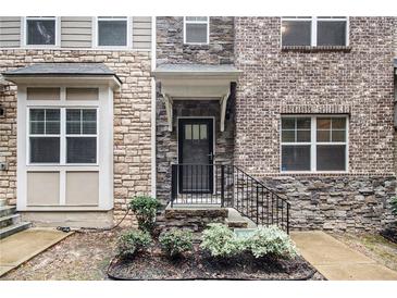 Inviting townhome exterior with stone accents and landscaping at 147 Kiram Ter, South Fulton, GA 30331