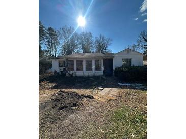 Ranch style home with a sunlit front yard at 2104 Cascade Sw Rd, Atlanta, GA 30311