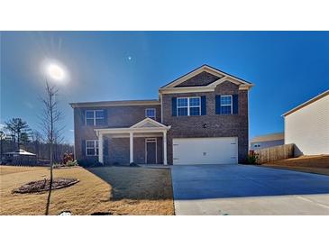 Two-story brick house with a large front yard and driveway at 2810 Torunn Ct, Atlanta, GA 30331
