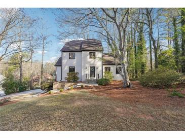 Charming two-story home featuring a well-maintained lawn and mature trees, providing curb appeal and a sense of tranquility at 3536 Evans Ridge Trl, Atlanta, GA 30340