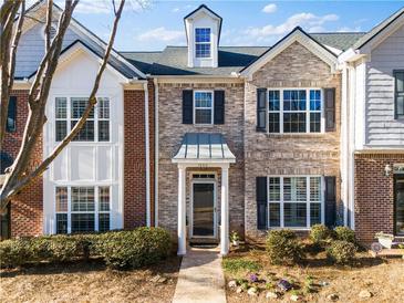 Brick front exterior of townhome with landscaping and walkway at 1680 Perserverence Hill Nw Cir # 23, Kennesaw, GA 30152