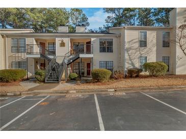 Inviting exterior of condo building with ample parking at 643 Windchase Ln, Stone Mountain, GA 30083