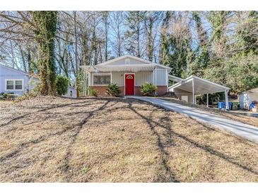 Charming single-story home with a red front door and cozy carport at 2720 Santa Barbara Nw Dr, Atlanta, GA 30318