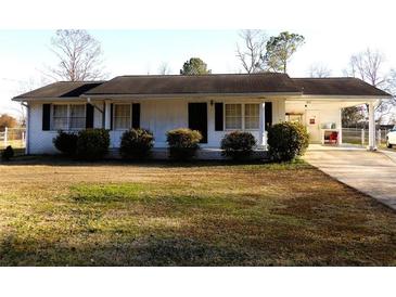 Ranch style home with carport and mature landscaping at 2104 Brownsville Rd, Powder Springs, GA 30127