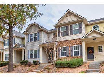 Charming townhome featuring stone accents, well-manicured landscaping, and inviting front entrance with stairs at 2637 Cedar Dr, Lawrenceville, GA 30043