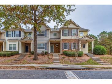 Three-story townhouses with stone accents and charming landscaping at 2637 Cedar Dr, Lawrenceville, GA 30043