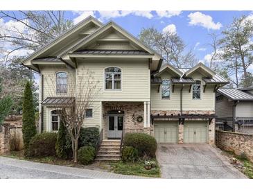 Charming two-story home with manicured landscaping, brick accents, and a two-car garage at 105 Weatherford Pl, Roswell, GA 30075