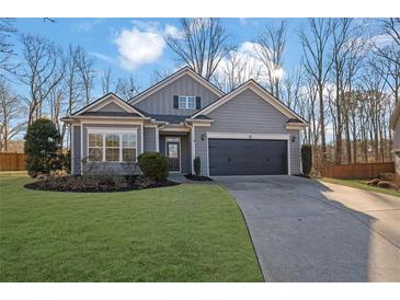 Charming single-Gathering home with a well-manicured lawn and a two-car garage in a residential neighborhood at 3490 Buffington Ln, Cumming, GA 30040