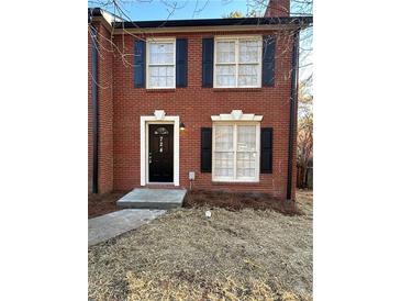 Charming brick townhouse with black shutters and a cozy front entrance at 724 Redland Dr, Jonesboro, GA 30238