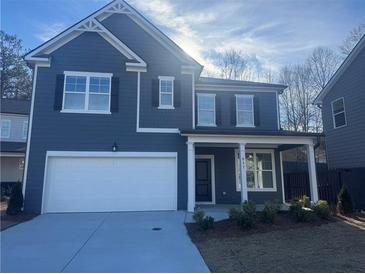 Two-story house with gray siding, white garage door, and landscaping at 817 River Gardens Se Dr, Atlanta, GA 30354