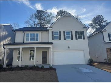 Two story house with beige siding, dark brown shutters and a two car garage at 799 River Gardens Se Dr, Atlanta, GA 30354