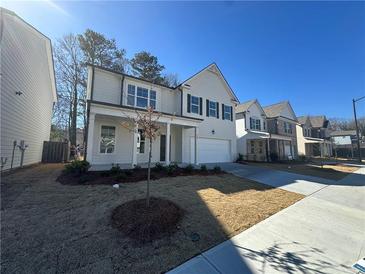 Two-story house with white siding, gray shutters, and a two-car garage at 799 River Gardens Se Dr, Atlanta, GA 30354