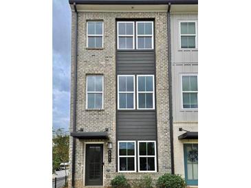 Three-story brick townhome with modern design and neutral color palette at 2651 Stream Nw Ter, Atlanta, GA 30318