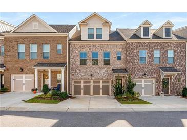 Three-unit townhome building with brick facade and two-car garages at 1590 Ridgebrook Downs, Mableton, GA 30126