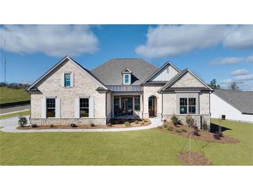 Two-story craftsman style home with light brick exterior, gray roof and landscaping at 233 Laurel Vista Dr, Canton, GA 30115