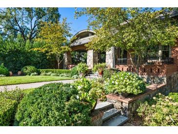 Charming brick home featuring an arched portico and lush, professionally landscaped front yard at 2220 Edison Ave, Atlanta, GA 30305