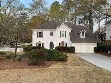 Charming two-story traditional home with a well-manicured lawn and attached garage at 5440 Cameron Forest Pkwy, Johns Creek, GA 30022
