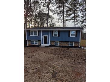 Newly renovated blue house with stone accents and a well-maintained lawn at 2320 Cherokee Valley Dr, Lithonia, GA 30058