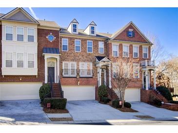 Brick townhome with 3-unit view, 2-car garage, and manicured landscaping at 4694 Wehunt Commons Se Dr # 25, Smyrna, GA 30082