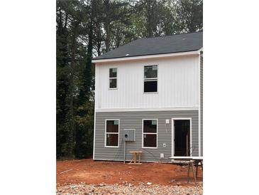 Two-story duplex with gray and white siding, featuring two windows on each level at 7240 Crestside Dr, Austell, GA 30168