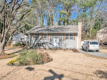 Gray house with brown accents, landscaping, and a driveway at 6460 Boca Grande Blvd, Forest Park, GA 30297