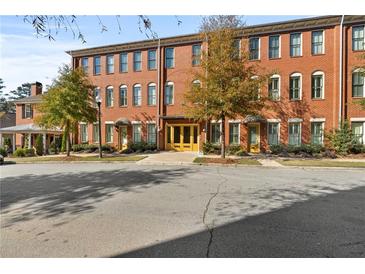 Brick building with multiple units and yellow doors at 4143 N Swann St, Covington, GA 30014