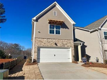 New construction home with brick and siding exterior, two-car garage, and landscaping at 261 Dahlia Dr, Woodstock, GA 30188