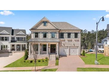 Brick two-story house with gray shutters, two-car garage, and landscaped lawn at 5247 Flannery Chase Sw, Powder Springs, GA 30127