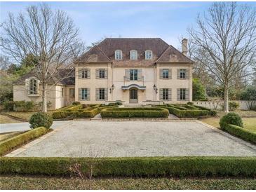 Stunning two-story home with a symmetrical facade, beautiful landscaping and a circular gravel driveway at 2631 Habersham Nw Rd, Atlanta, GA 30305