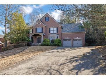 Brick home with three-car garage and long driveway at 1325 Cameron Glen Dr, Marietta, GA 30062