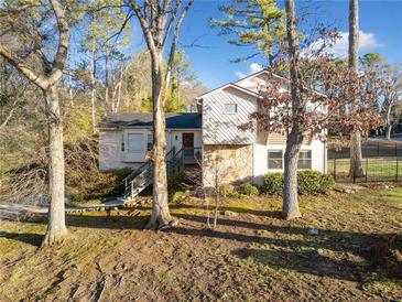 Charming home with a stone facade, inviting entrance, and landscaped front yard at 749 Scarlet Ne Dr, Kennesaw, GA 30144