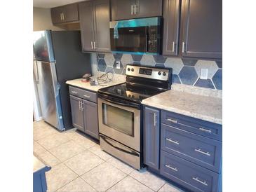 Modern kitchen with stainless steel appliances and updated cabinets at 6354 Shannon Pkwy # 6C, Union City, GA 30291