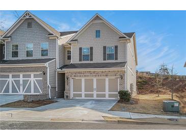 Charming two-story home with a brick and shingle facade and a two-car garage at 366 Cherryhill Ln, Woodstock, GA 30188