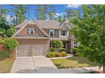 Beautiful two-story brick home with a two-car garage and manicured landscaping at 231 Haney Rd, Woodstock, GA 30188