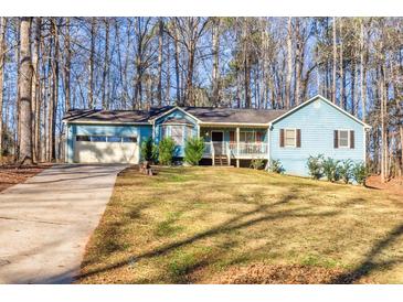 Ranch style home with attached garage, and a spacious front yard at 215 Silver Creek Ln, Stockbridge, GA 30281